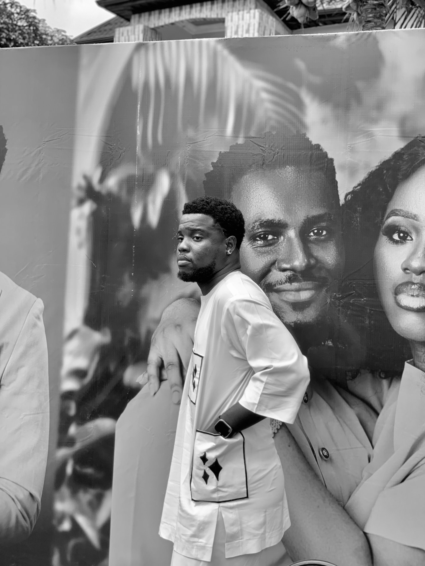Emmanuel Excellence Ugochukwu standing before a large photographic display